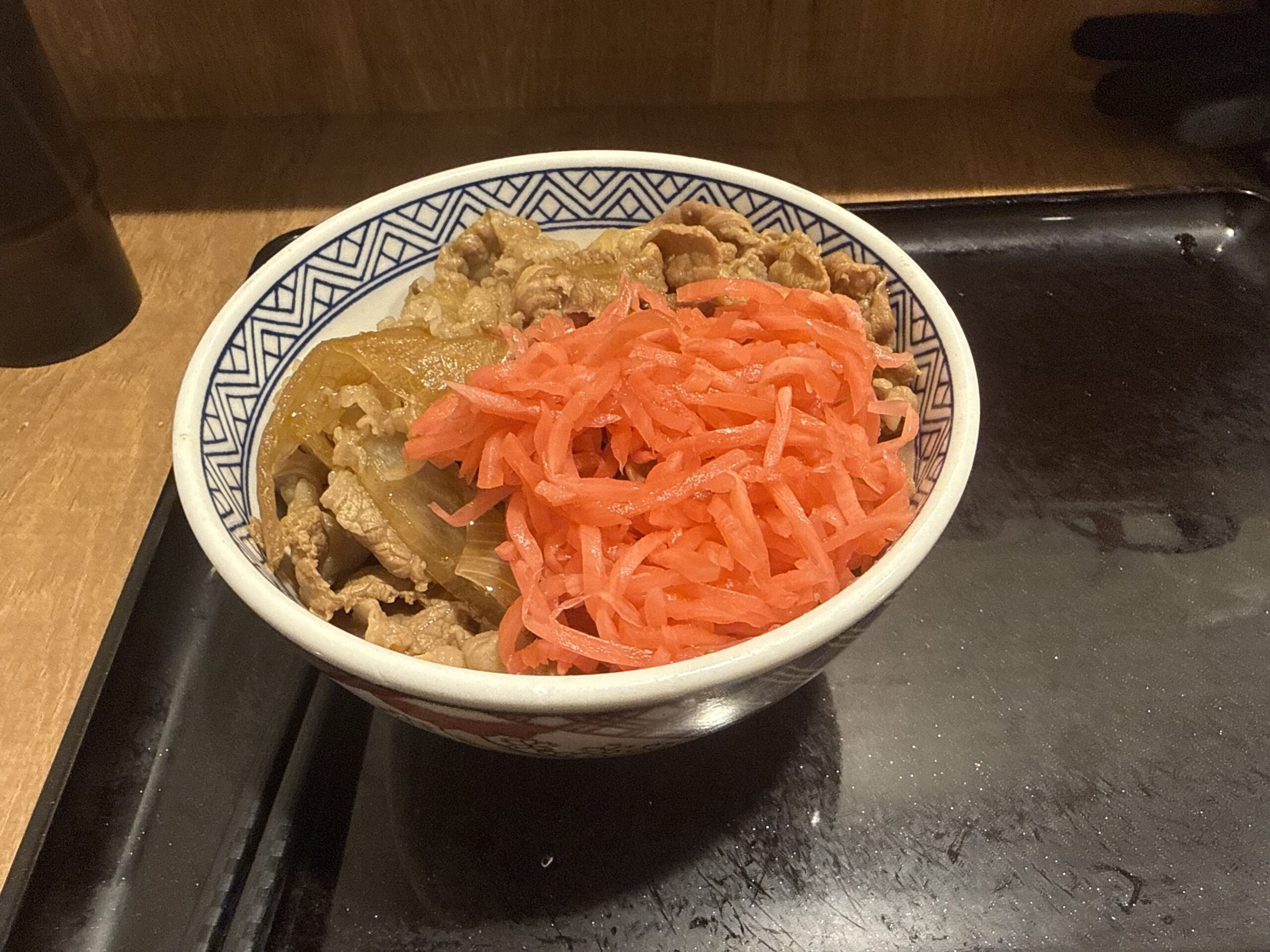 Yoshinoya gyudon topped with red pickled ginger (beni-shoga)